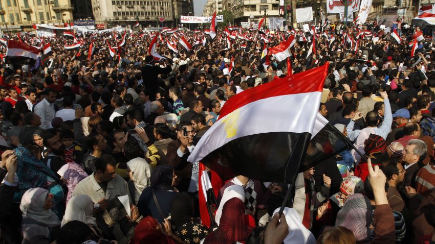 Tens of thousands of anti-government supporters wave national flags as they gather for the 15th consecutive day to demonstrate in central Cairo's Tahrir Square on February 8, 2011, demanding the ouster of embattled Egyptian President Hosni Mubarak. AFP PHOTO/MOHAMMED ABED (Photo credit should read MOHAMMED ABED/AFP via Getty Images)