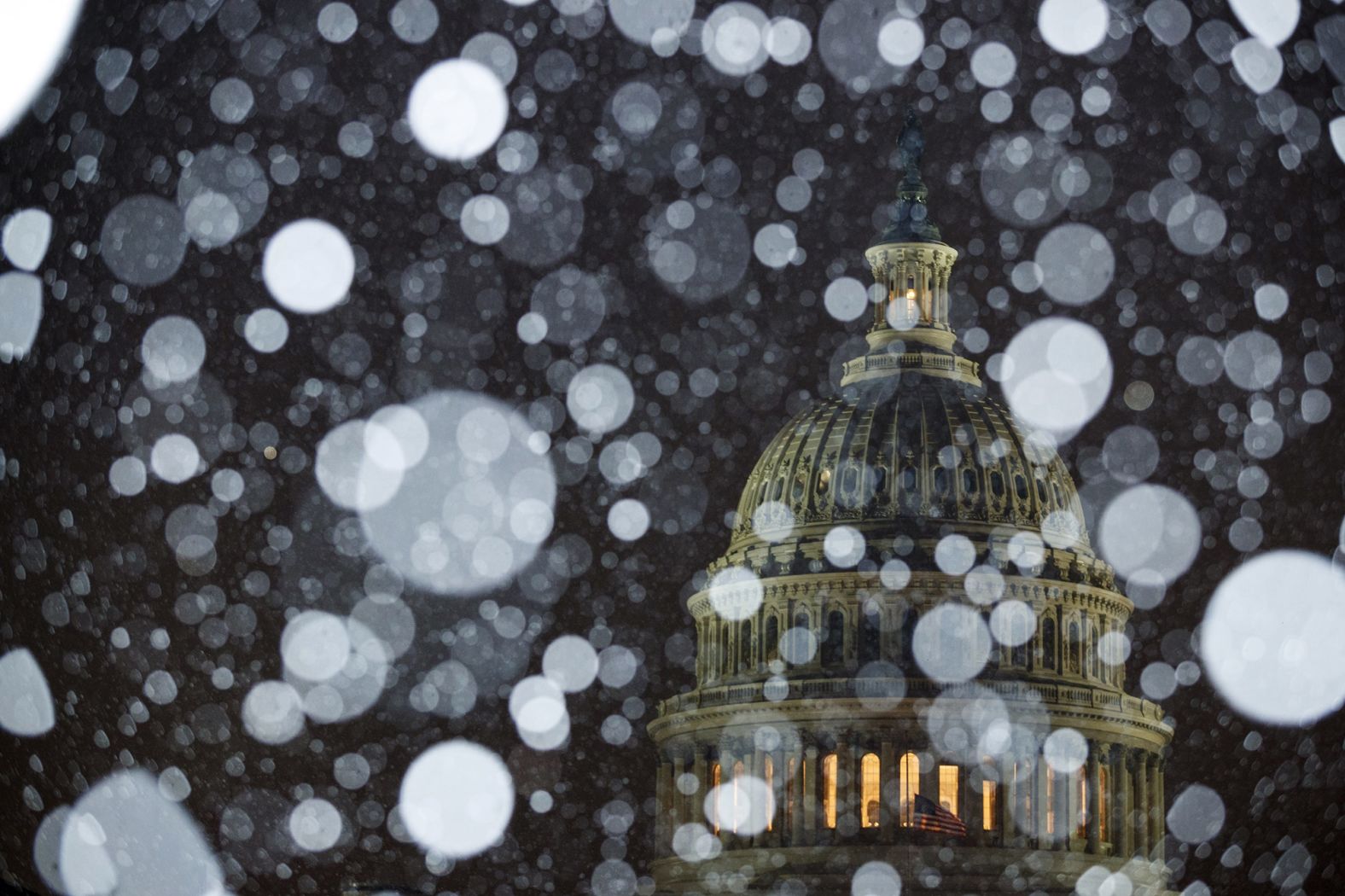 Snow falls outside the Capitol on Wednesday.