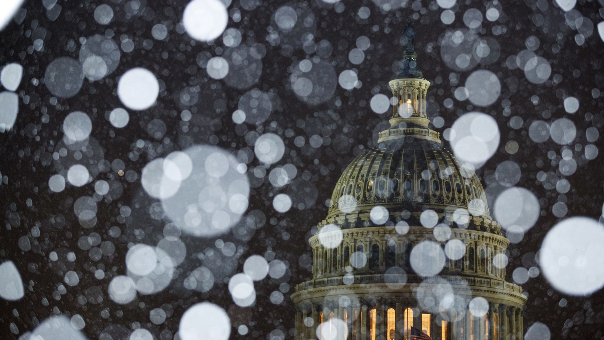 Snow falls outside the Capitol on Wednesday.