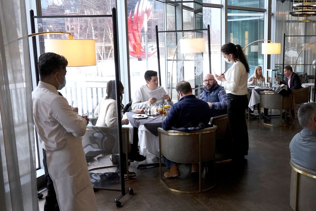 Patrons eat lunch indoors on January 27 at Gibsons Italia restaurant in Chicago.