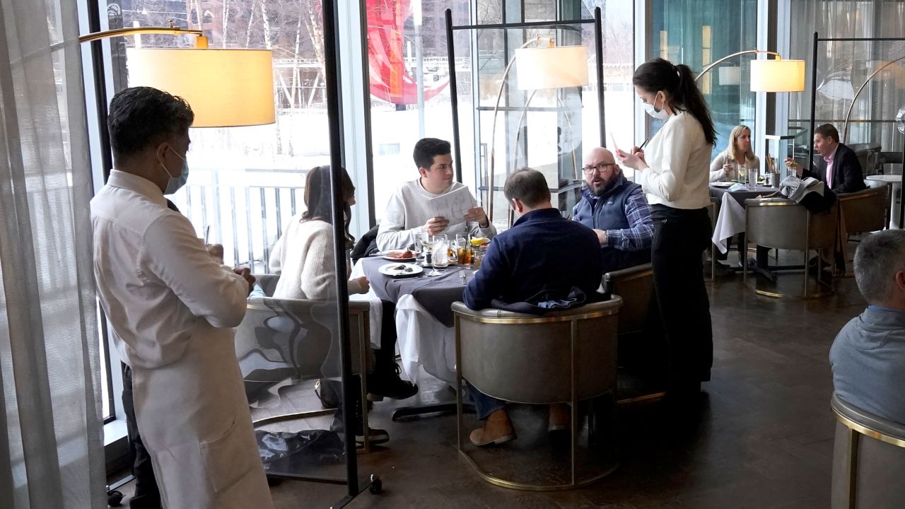 Patrons eat lunch indoors on January 27 at Gibsons Italia restaurant in Chicago.