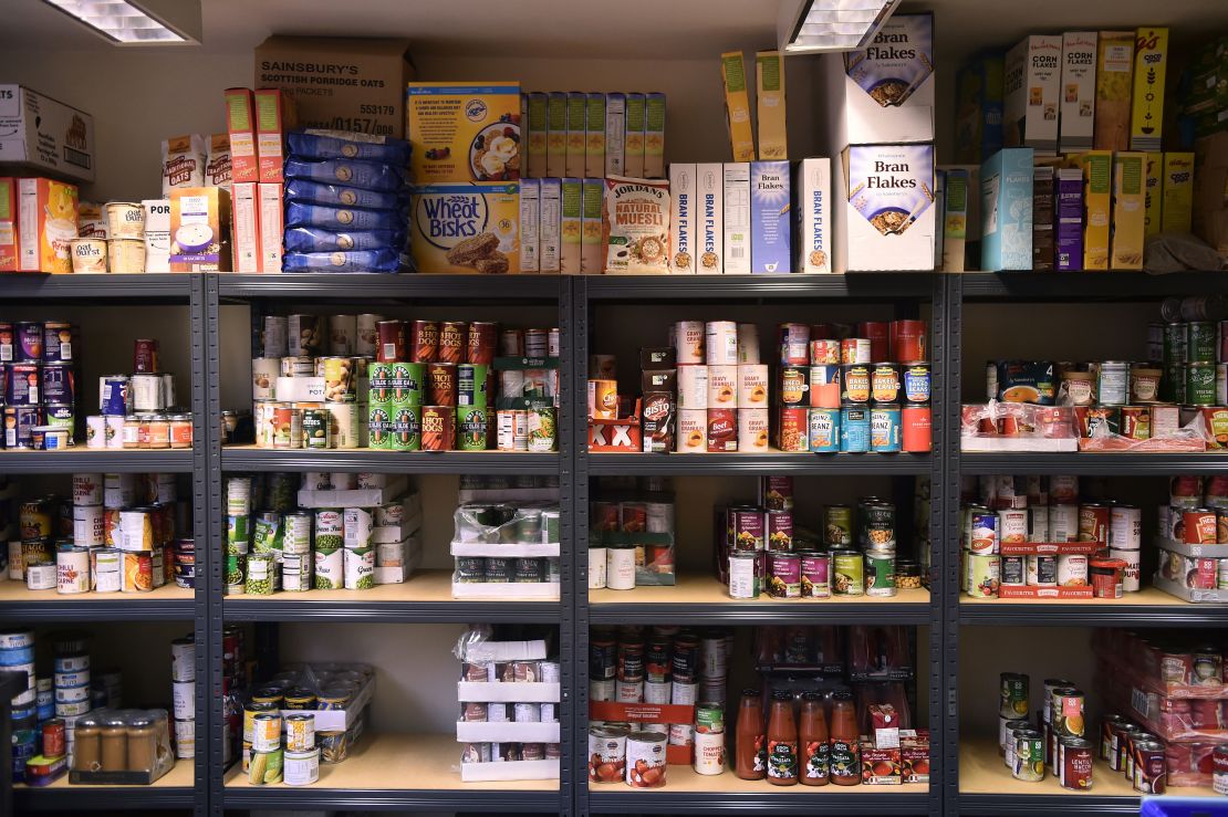 Cans of food are left on the shelves at a food bank in Newcastle-under-Lyme, England. 