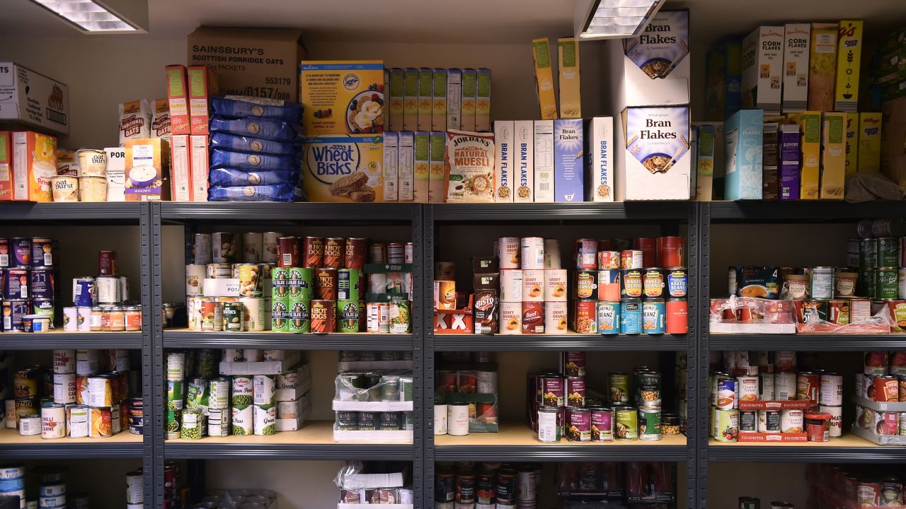 Cans of food are left on the shelves at a food bank in Newcastle-under-Lyme, England. 