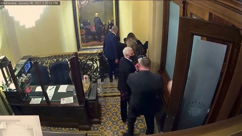 In this image from video shown during Wednesday's impeachment trial, a security video shows then-Vice President Mike Pence being evacuated as rioters breach the Capitol.