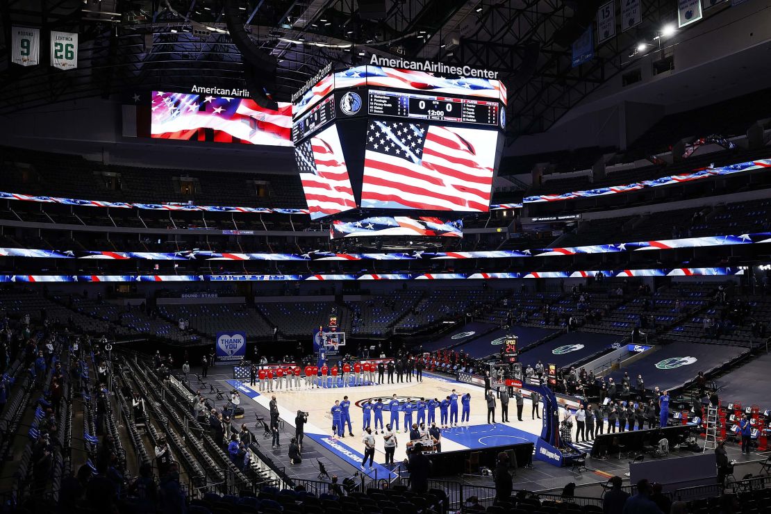 The Mavericks and the Atlanta Hawks stand for the National Anthem prior to tipoff of their NBA game.