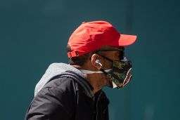 A man wears a double mask as he walks in Times Square in New York City.