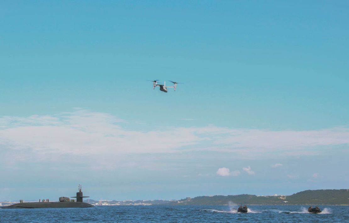 A US Marine Corps MV-22B Osprey and Marines in a small watercraft conduct an exercise with the guided-missile submarine USS Ohio off the coast of Okinawa, Japan, earlier this month. 