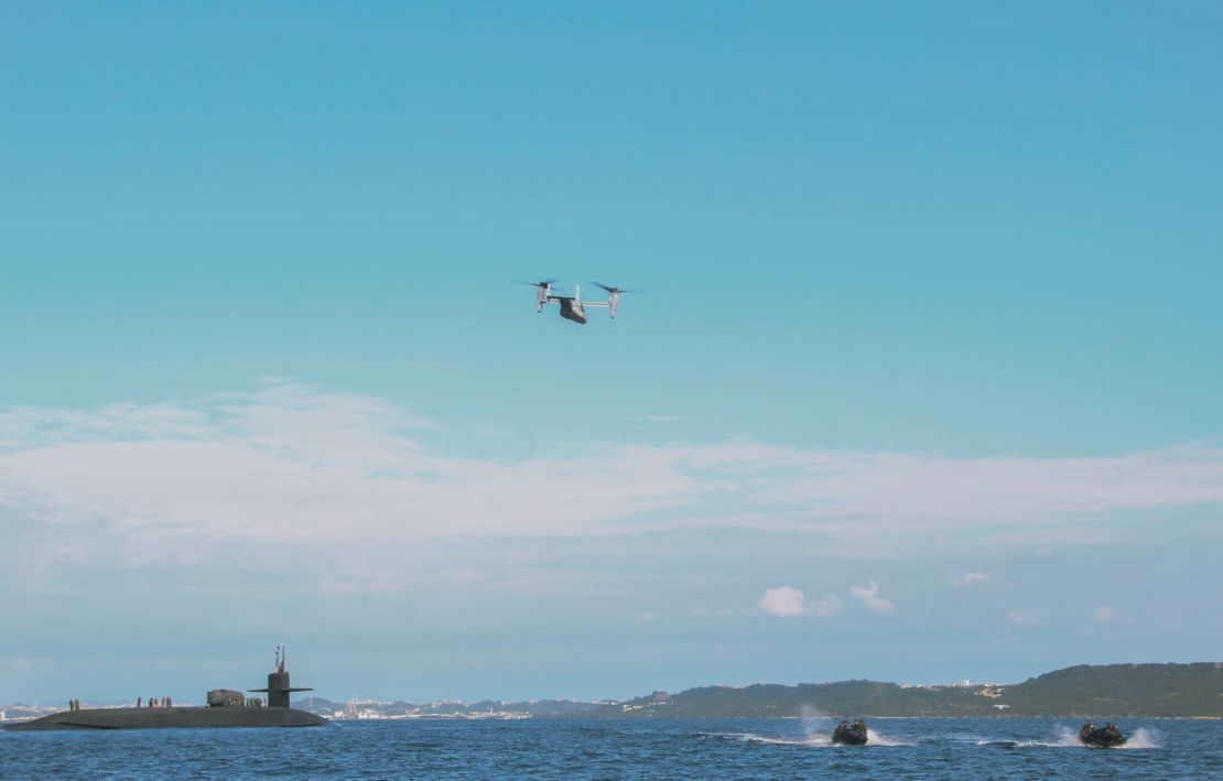 A US Marine Corps MV-22B Osprey and Marines in a small watercraft conduct an exercise with the guided-missile submarine USS Ohio off the coast of Okinawa, Japan, earlier this month.