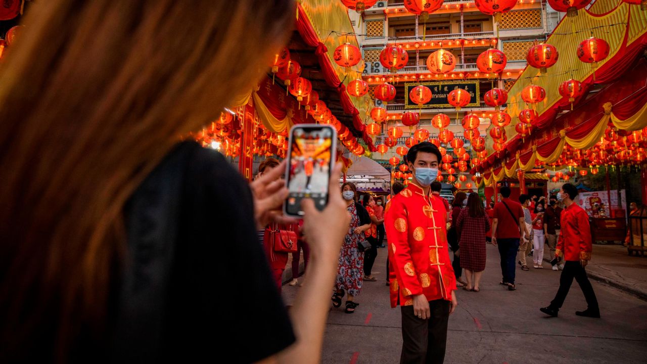 People take selfies in the Chinatown area of Bangkok, Thailand, on Thursday, February 11. The neighborhood was filled with Lunar New Year decorations.