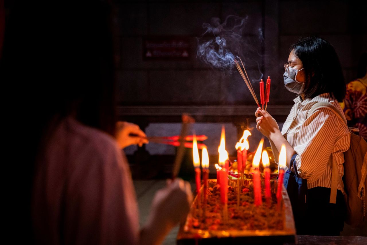 People pray at Wat Mangkon, a Buddhist temple in Bangkok's Chinatown.