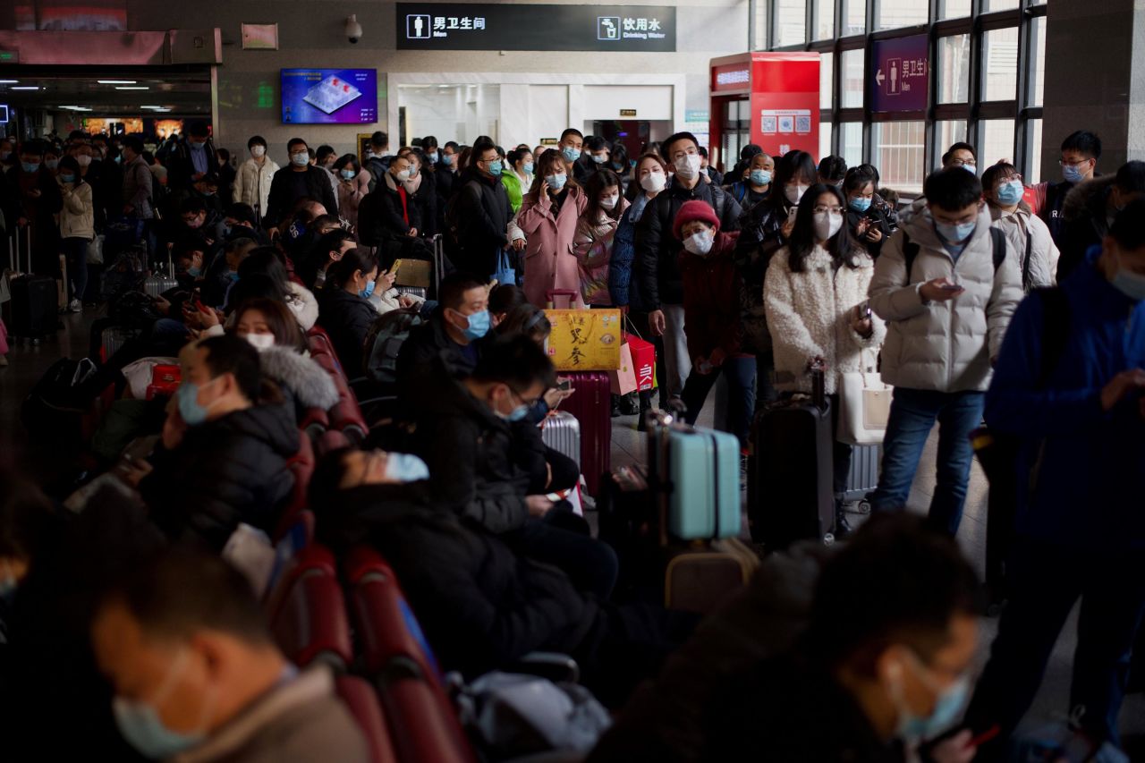 Passengers line up at a railway station in Beijing on February 10.
