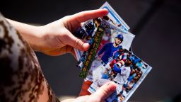 MESA, AZ - FEBRUARY 18:  A young fan plays with baseball cards of the Chicago Cubs during a workout after Photo Day on Tuesday, February 18, 2020 at Sloan Park in Mesa, Arizona.  (Photo by Adam Glanzman/MLB Photos via Getty Images)