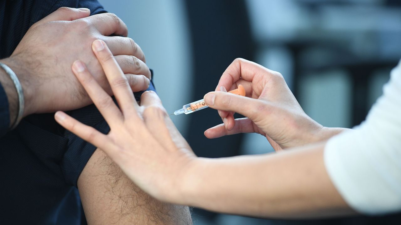 A pharmacist administers an AstraZeneca Covid-19 vaccine injection at the Black Country Living Museum in Dudley, central England, on January 25, 2021.