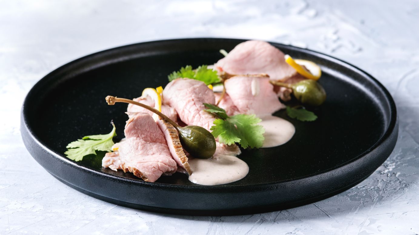 <strong>Vitello tonnato: </strong>Italy's answer to surf and turf, thin sliced veal is covered with a dense layer of mayonnaise mixed with shredded tuna, anchovies and capers.