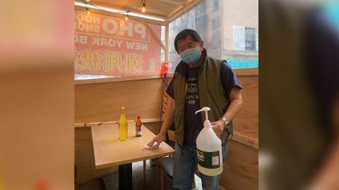 New York City Chinatown restaurant owner Chi Vy Ngo stands in a vestibule outside his "Bo Ky" Chinese and Vietnamese noodle shop on Bayard Street in Manhattan on January 11, 2021.