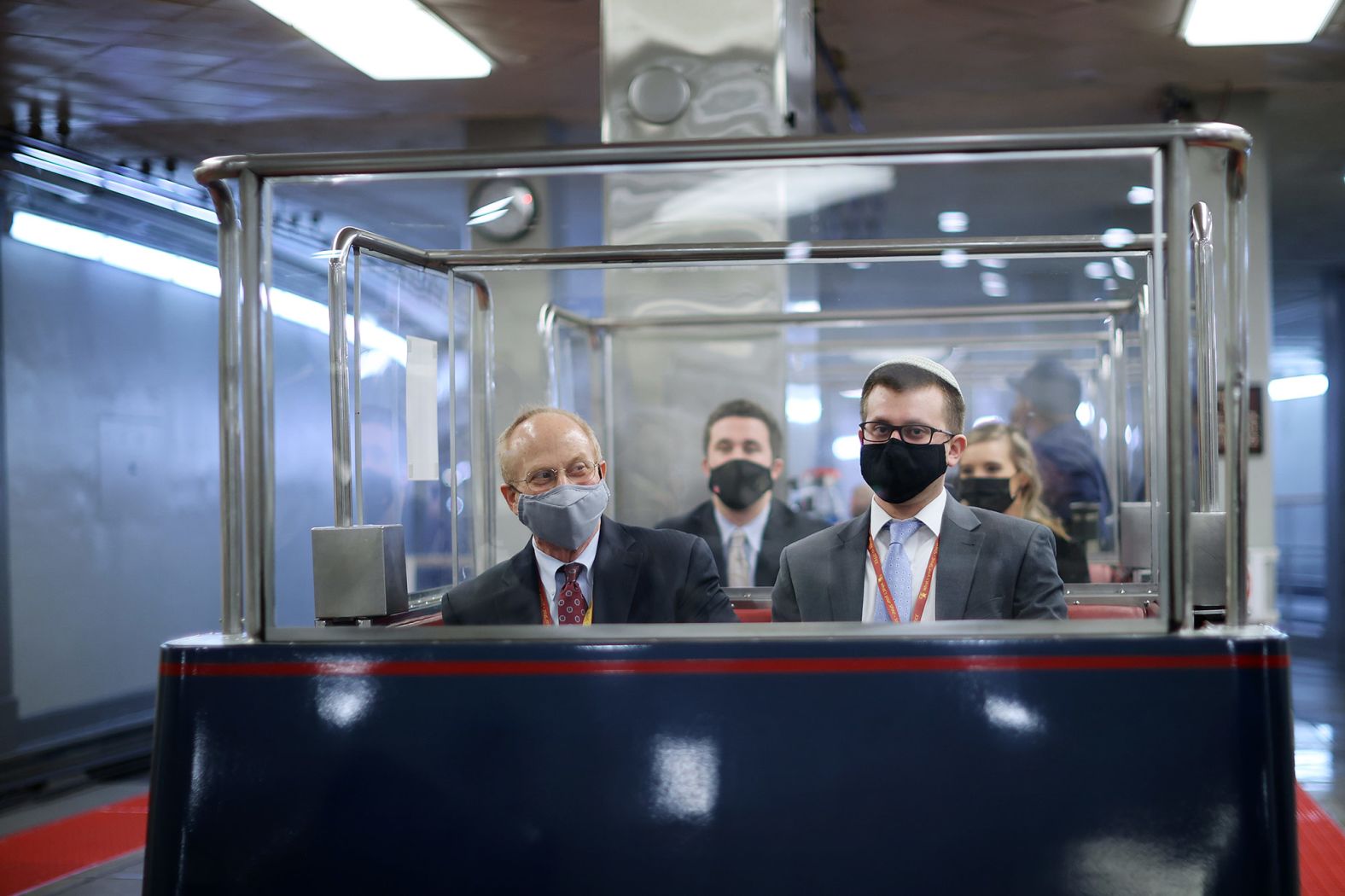 Defense lawyer David Schoen, left, rides a subway train at the Capitol on Thursday.