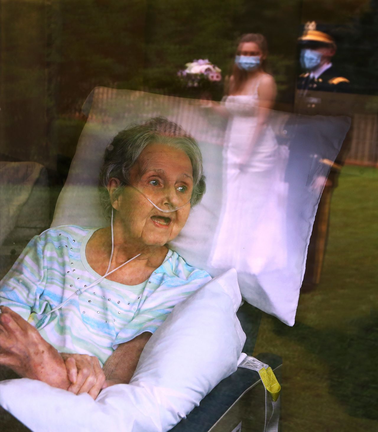 Jacqueline Cavender, 84, reacts as her grandson, US Army 2nd Lt. Robert Costea, and his bride, Sarah, recreate their wedding for her outside a medical facility in Jackson, Georgia, on June 7.