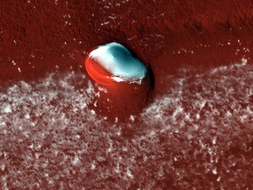 HiRISE captured layered deposits and a bright ice cap at the Martian north pole.