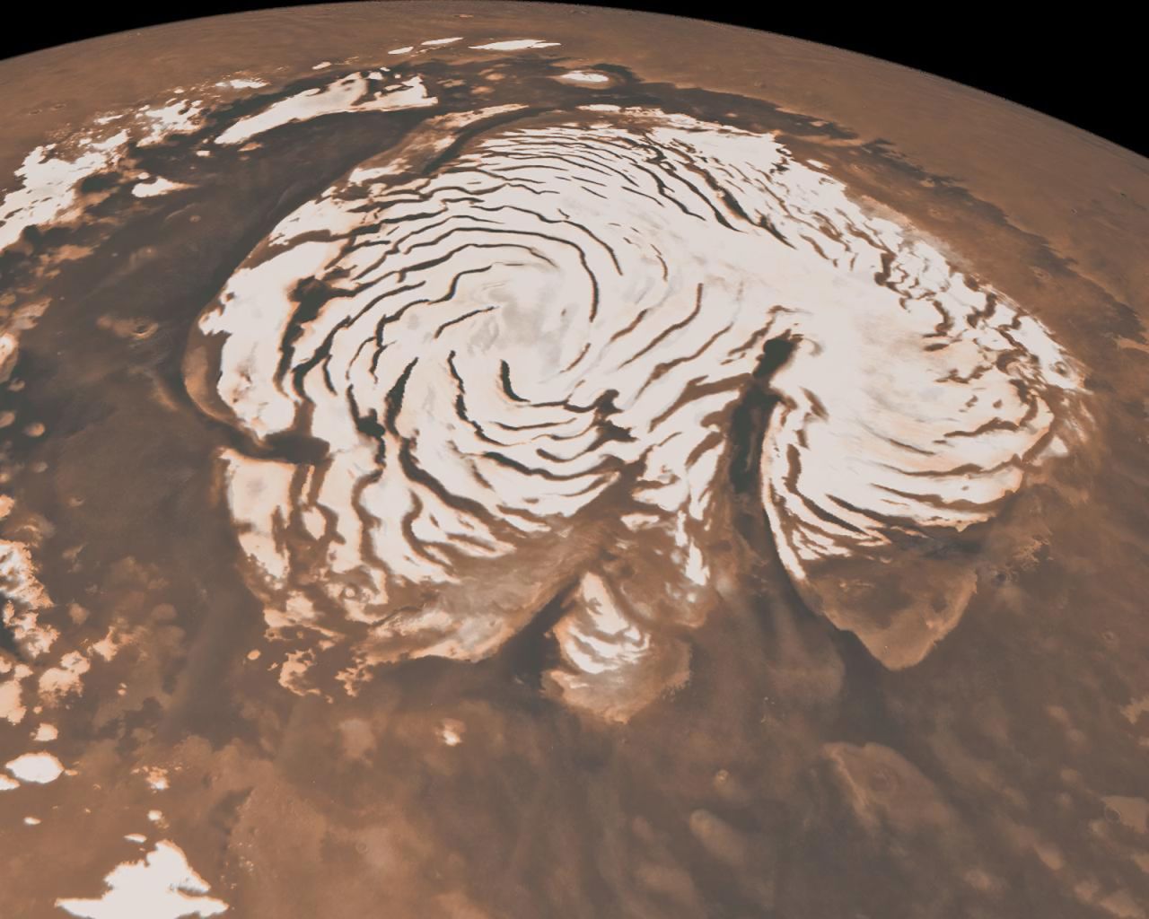 This image, combining data from two instruments aboard NASA's Mars Global Surveyor, depicts an orbital view of the north polar region of Mars. The ice-rich polar cap is 621 miles across, and the dark bands in are deep troughs. To the right of center, a large canyon, Chasma Boreale, almost bisects the ice cap. Chasma Boreale is about the length of the United States' famous Grand Canyon and up to 1.2 miles deep.