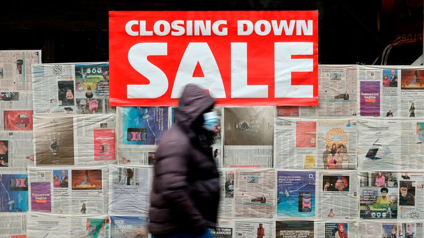 A pedestrian wearing a face mask as a precautionary measure against COVID-19, walks past a closed-down shop in the City of London on January 15, 2021. - Britain's economy slumped 2.6 percent in November on coronavirus restrictions, official data showed January 15, 2021, stoking fears that the current virus lockdown could spark a double-dip recession. (Photo by Tolga Akmen / AFP) (Photo by TOLGA AKMEN/AFP via Getty Images)