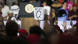 An attendee holds signs with the words "We Are Q" before the start of a rally with U.S. President Donald Trump in Lewis Center, Ohio, U.S., on Saturday, Aug. 4, 2018. Photographer: Maddie McGarvey/Bloomberg via Getty Images
