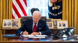 U.S. President Joe Biden signs executive actions in the Oval Office of the White House on January 28, 2021 in Washington, DC. 