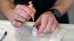 A member of the Hampshire Fire and Rescue Service prepares a dose of a AstraZeneca/Oxford Covid-19 vaccine at a temporary vaccination centre set up at Basingstoke Fire Station, in Basingstoke, Hampshire, southern England, on February 4, 2021, as crews continue to take 999 emergency calls. - Oxford University announced on Thursday it will launch a medical trial alternating doses of Covid-19 vaccines created by different manufacturers, the first study of its kind. (Photo by Andrew Matthews / POOL / AFP) (Photo by ANDREW MATTHEWS/POOL/AFP via Getty Images)