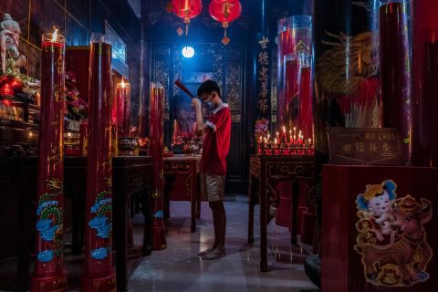 A man prays at a temple in Yogyakarta, Indonesia, on the eve of Lunar New Year.