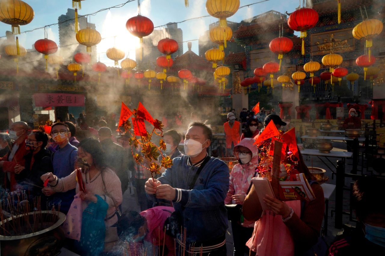 Worshippers wear face masks as they pray at the Wong Tai Sin Temple in Hong Kong on Friday, February 12.
