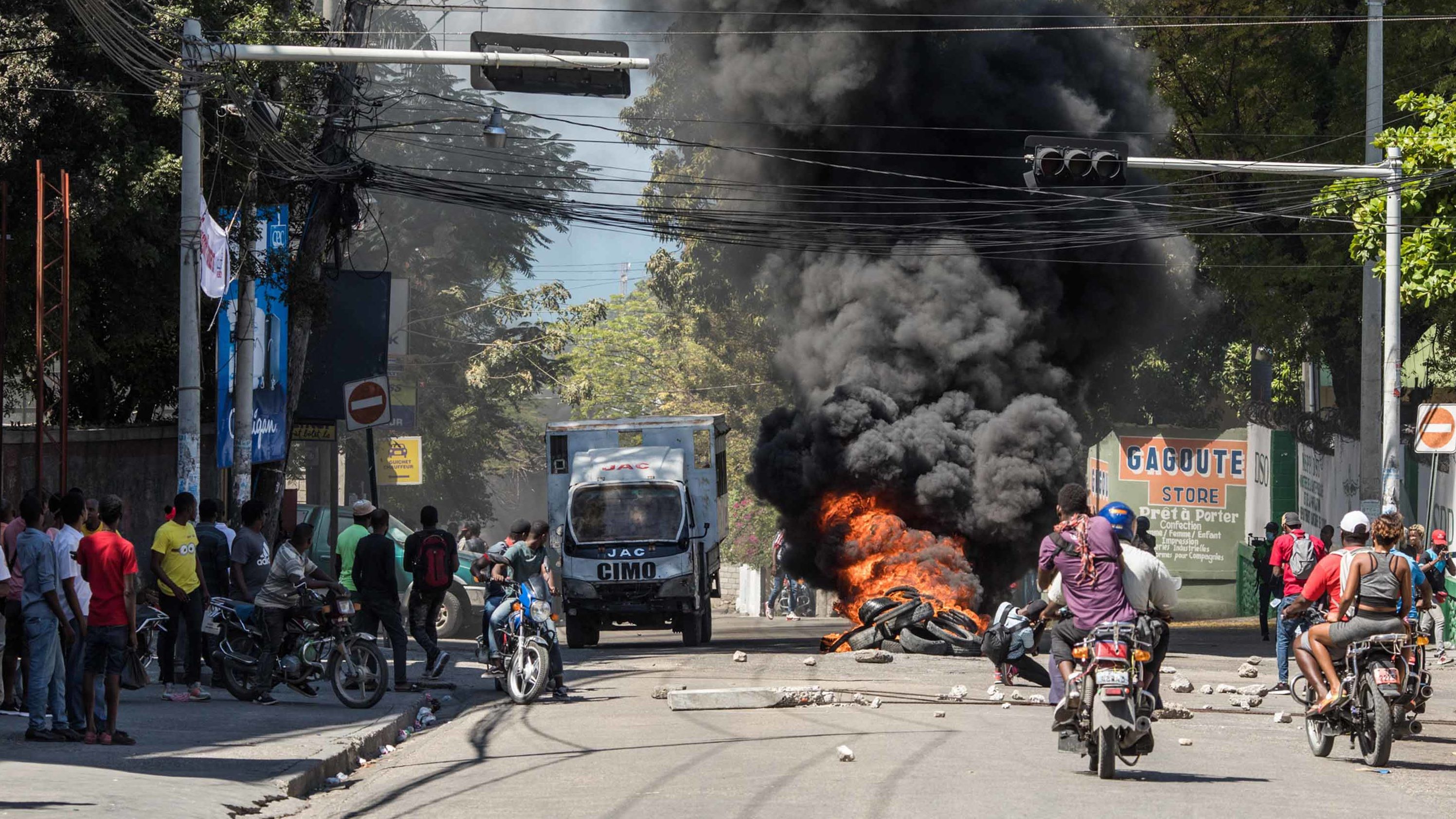 Tires are set ablaze during a march in Port-au-Prince on February 10, 2021, to protest against the government of President Jovenel Moise.