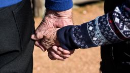 An elderly couple walk hand-in-hand in San Antonio, Texas. (Photo by Robert Alexander/Getty Images)
