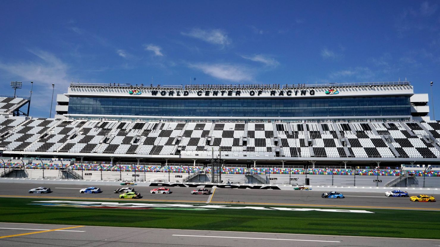 Cars race through the front stretch at Daytona International Speedway during a NASCAR Daytona 500  practice session on Wednesday, February 10.