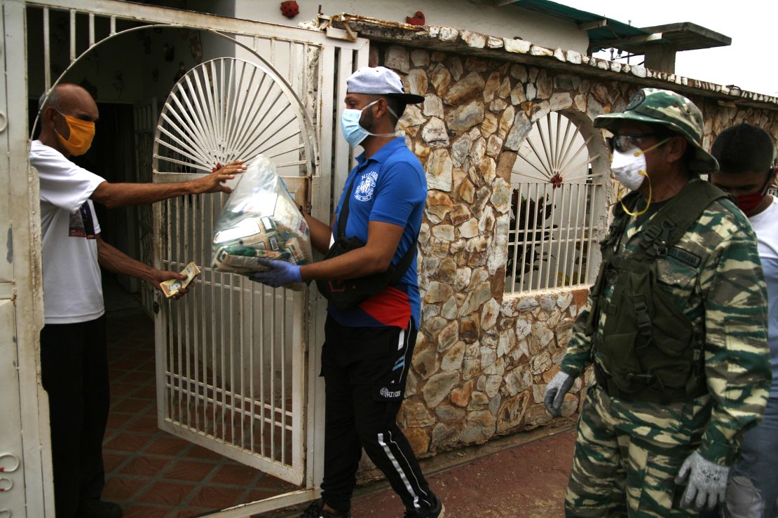 Inhabitants of the Manzanillo sector receive food bags on April 1, 2020, south of the municipality of San Francisco, Venezuela.