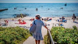 A woman arrives at Bellevue beach in Aarhus, Denmark on August 7, 2020. - A heatwave has hit Denmark on Friday as the high temparatures are supposed to last throughout the weekend. (Photo by Michael Drost-Hansen / Ritzau Scanpix / AFP) / Denmark OUT (Photo by MICHAEL DROST-HANSEN/Ritzau Scanpix/AFP via Getty Images)