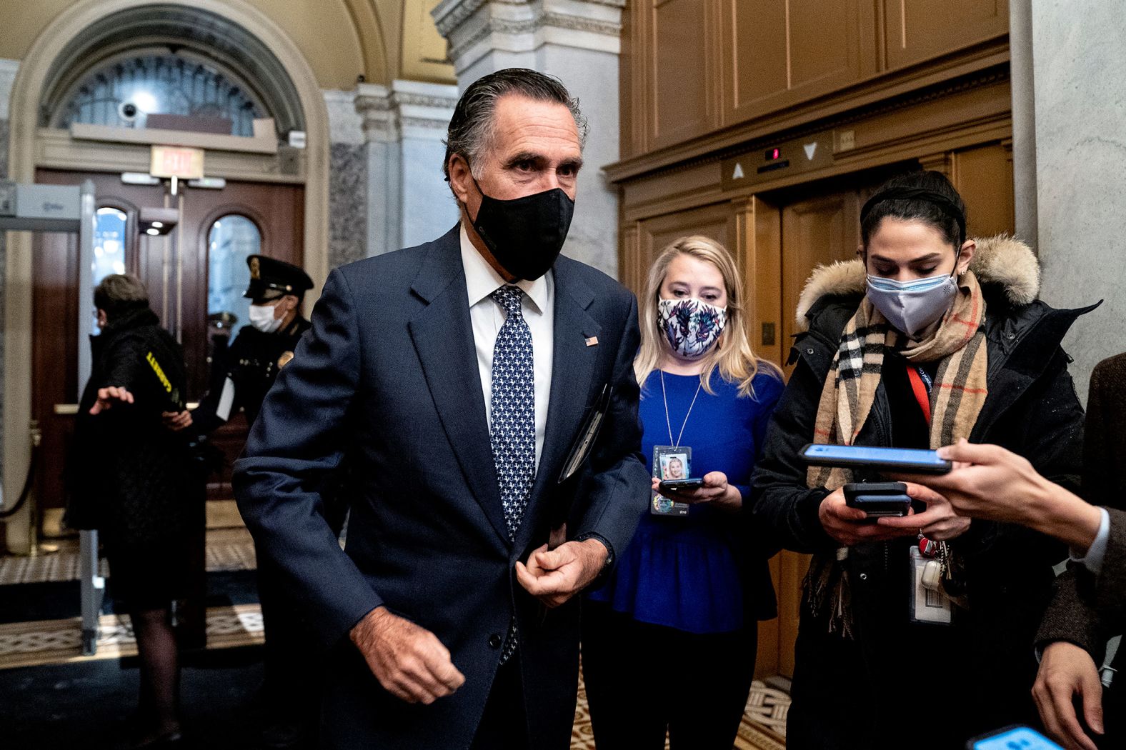 US Sen. Mitt Romney speaks to reporters as he arrives at the Capitol on Saturday. Romney was one of the seven Republican senators who joined Democrats in voting guilty.