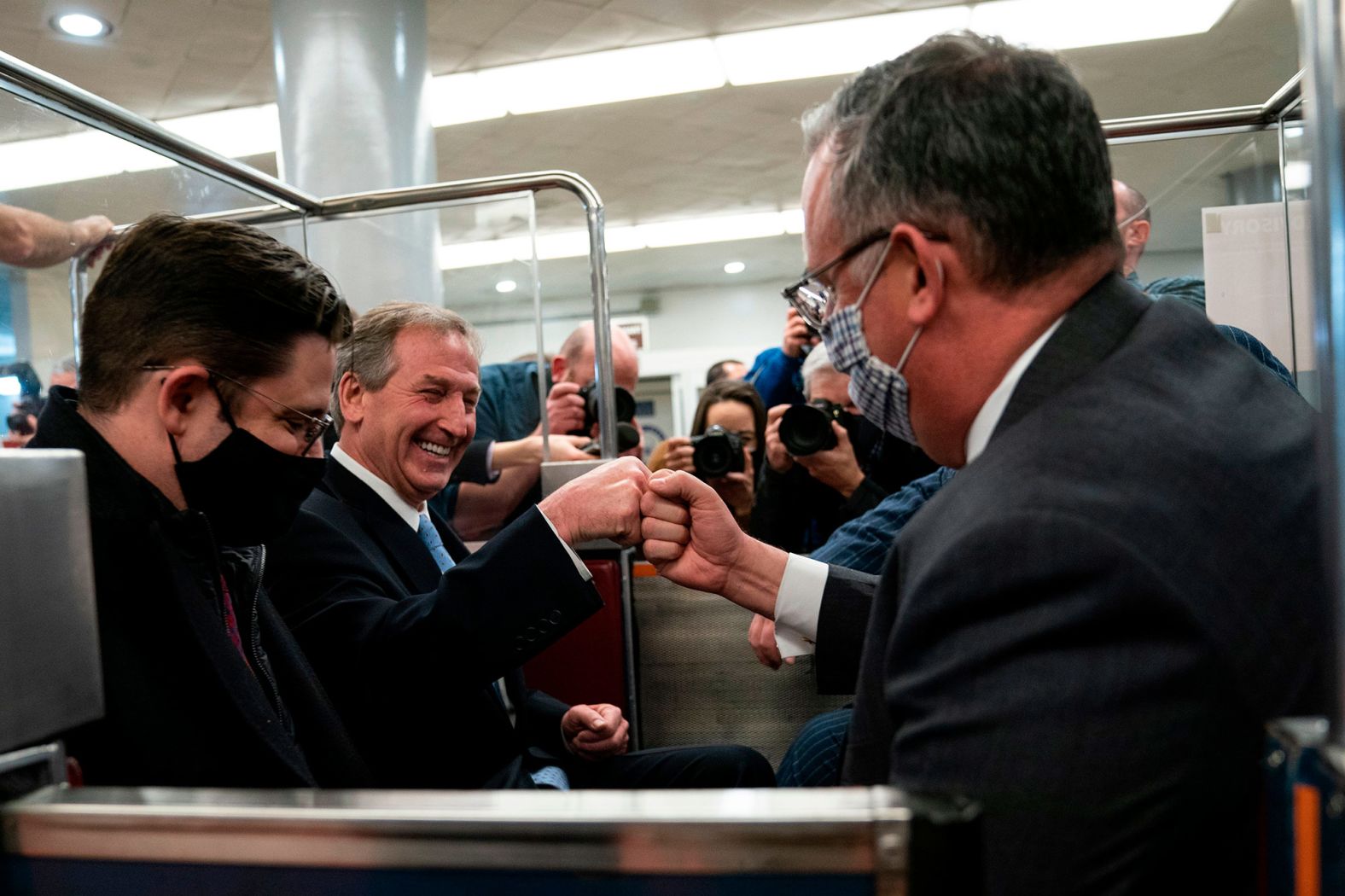 Trump lawyer Michael van der Veen, second from left, celebrates after the vote.