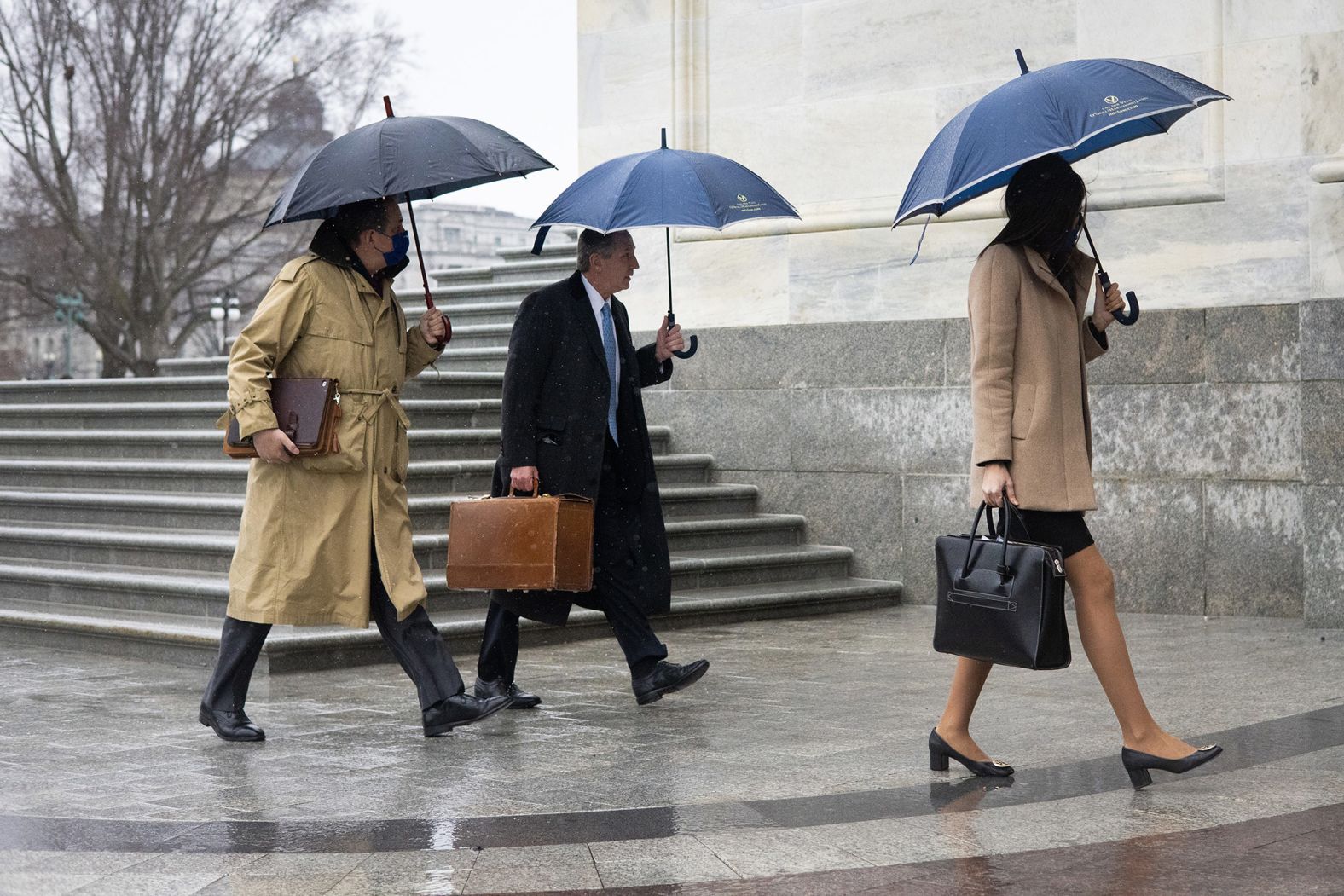 Trump lawyers Bruce Castor, left, and Michael van der Veen, center, arrive at the Capitol on Saturday.