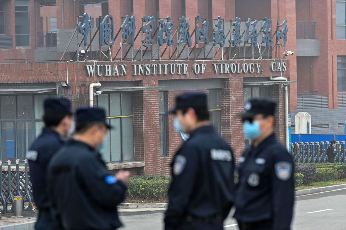 Security personnel stand guard outside the Wuhan Institute of Virology as members of the WHO team investigating the origins of Covid-19 visit China's central Hubei province on February 3, 2021.