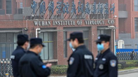 Security personnel stand guard outside the Wuhan Institute of Virology as members of the WHO team investigating the origins of Covid-19 visit China's central Hubei province on February 3, 2021.