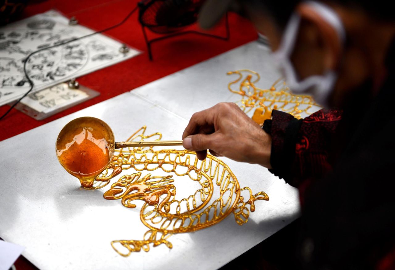 An artist in Tianjin, China, makes a candy painting on February 13.