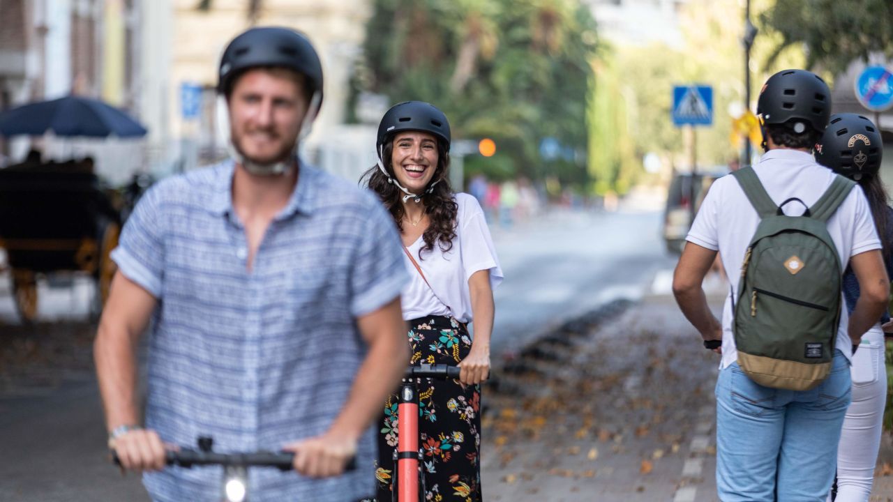 Cities should make roads safer for e-scooters, deterring riders from using the sidewalk, says the International Transport Forum.