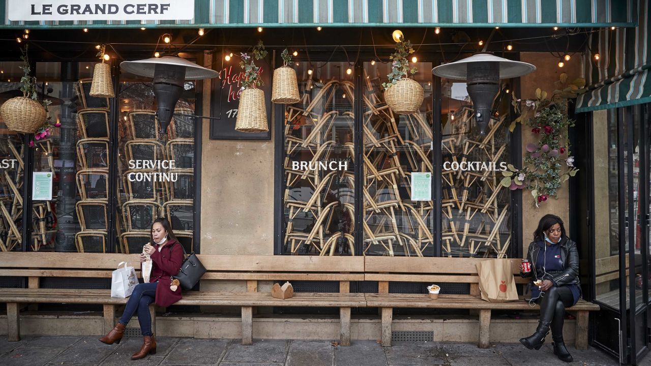 People eat their lunch outside a closed restaurant on February 1 in Paris.