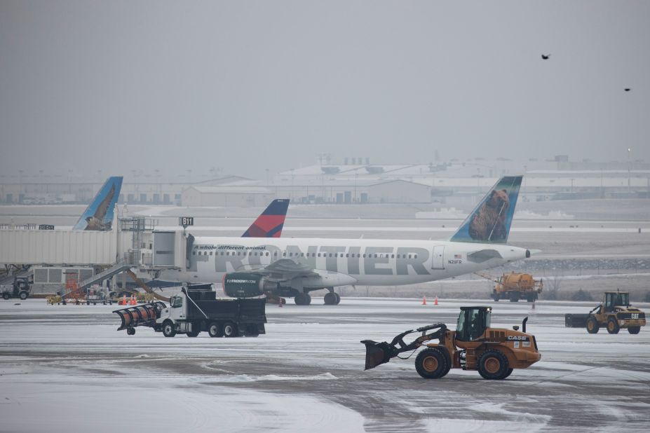 Vehicles clear ice at the international airport in Nashville, Tennessee, on Monday.