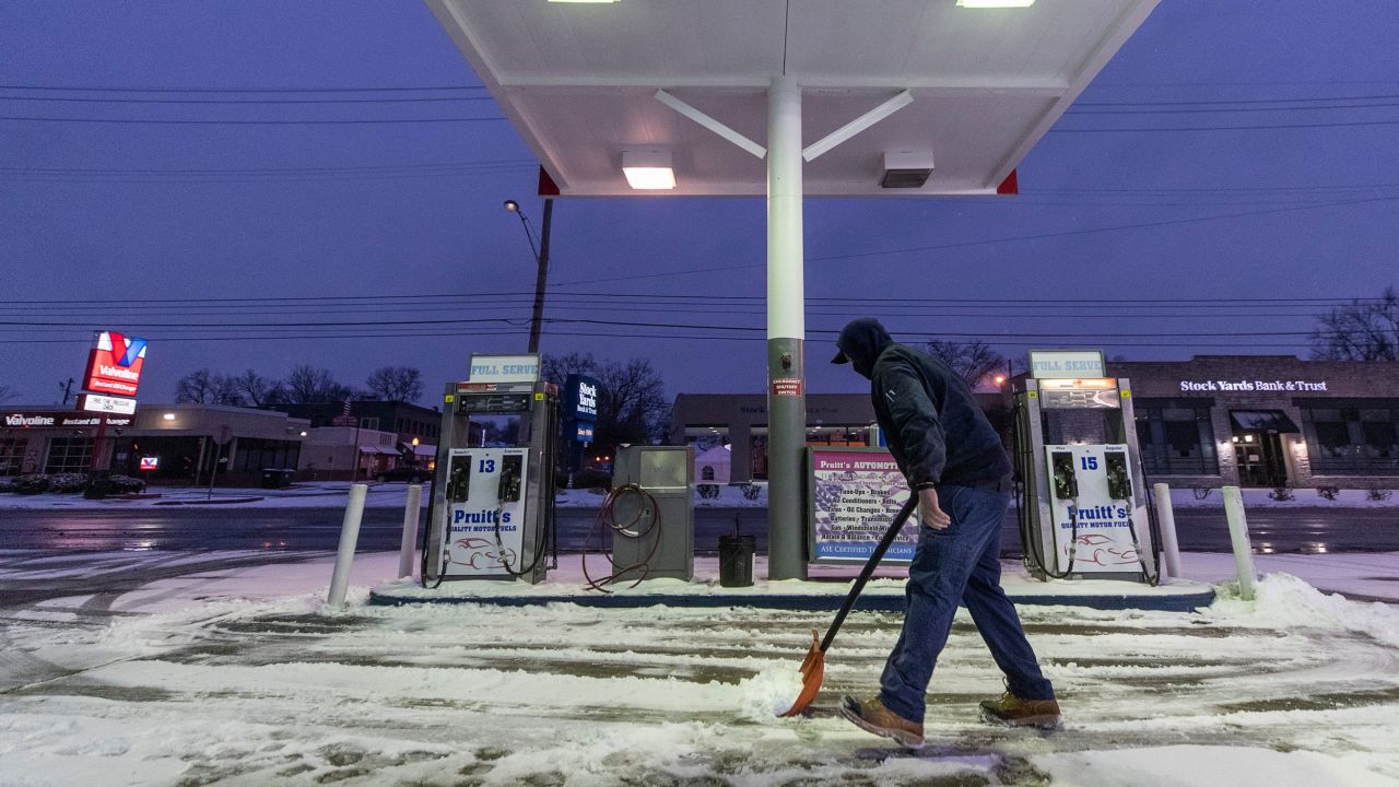 Kirk Caudill shovels away snow from the storm at Pruitt's Auto Service, in St. Matthews, Kentucky.