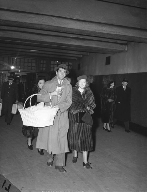 A baby Fonda is carried in a basket by her father, actor Henry Fonda, as he and Jane's mother, Frances, walk to a train in New York in 1938.