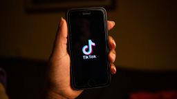New York, United States, 6th January 2021: A woman holds a phone with the TIKTOK logo in her hand. It's one of the most popular social networks at the moment.