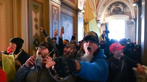 A man wearing an Oath Keepers hat yells in the hallways of the Capitol during the invasion by rioters on January 6.