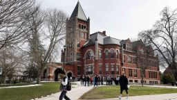 In this photo taken Wednesday April 6, 2016 students walk past the historic Thompson Hall at the University of New Hampshire in Durham, N.H. The water system serving the University is among more than two dozen in New Hampshire that have exceeded the federal lead standard at least once in the last three years. (AP Photo/Jim Cole)