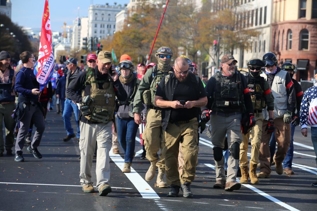 Rhodes, center in eye patch, marches with Oath Keepers through Washington, DC last November. Watkins is visible behind him to his right, wearing jeans and goggles on her ballistic helmet. 