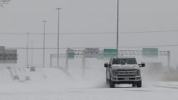 Vehicles driving on snow-covered Interstate 10 Monday, Feb. 15, 2021, in Houston. A winter storm making its way from the southern Plains to the Northeast is affecting air travel. (Yi-Chin Lee/Houston Chronicle via AP)